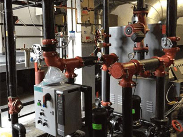 Room containing an assortment of pipes and valves in Edmonton, AB