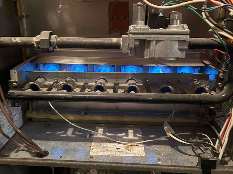 The gas furnace with blue lights was opened for repair in Edmonton, AB.