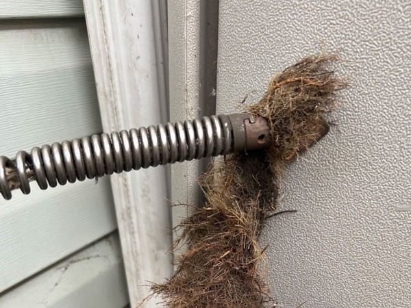 Metal spring on a door serving as a functional component for smooth door movement in Edmonton, AB