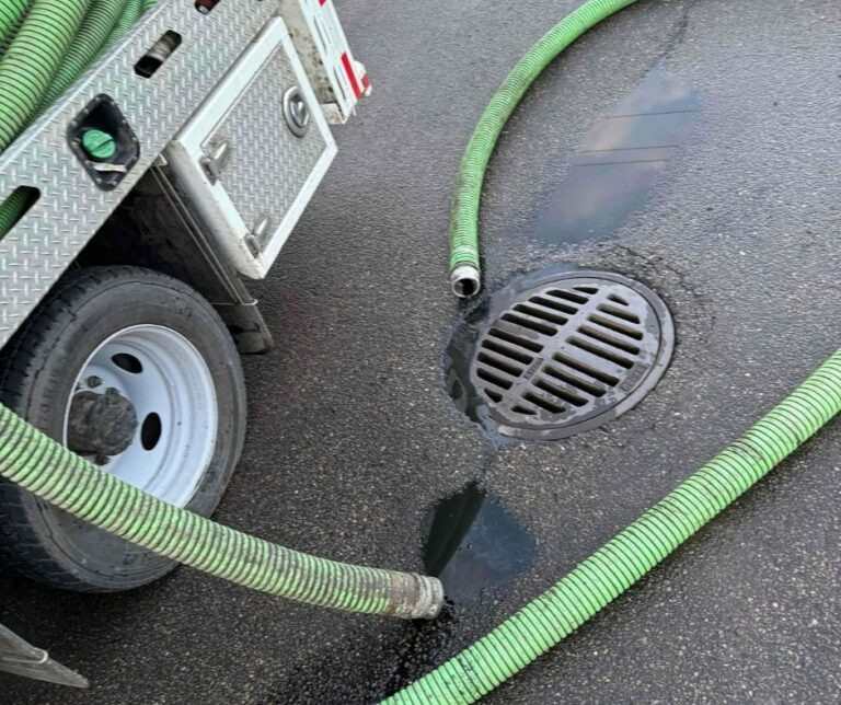 Hydro-Flo workers and trucks outside a building in Edmonton, AB