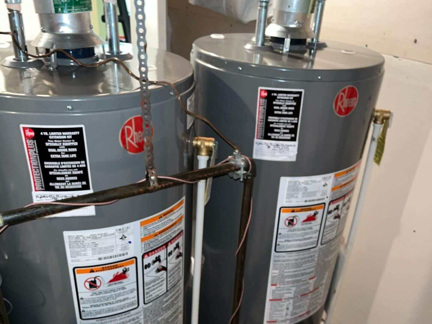 Two gas water heaters installed in a utility room in Edmonton, AB