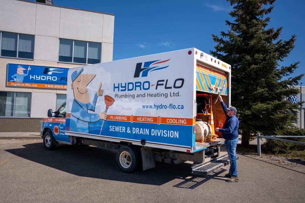 Hydro-Flo service truck with plumbing technician unloading equipment