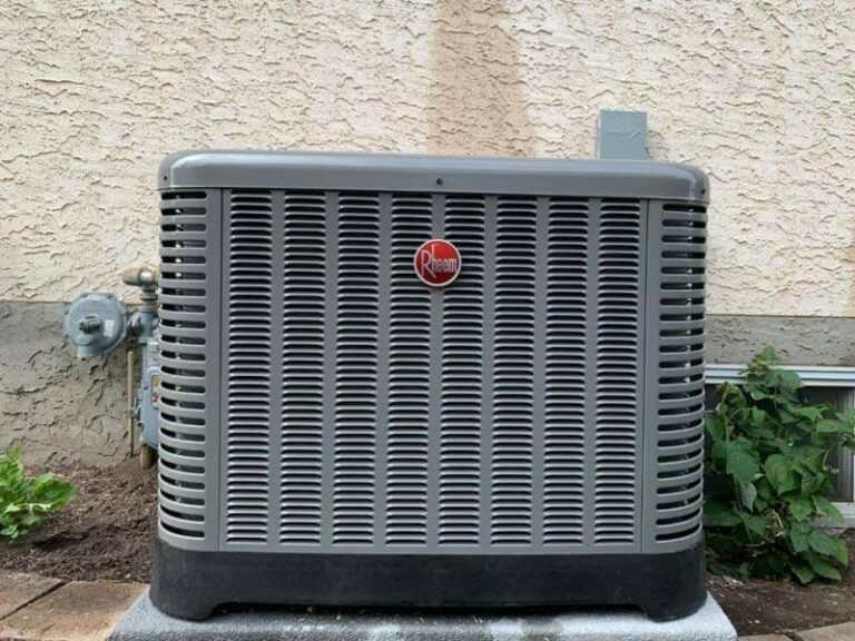 Gray air conditioner installed as part of a Rheem installation in Edmonton, AB