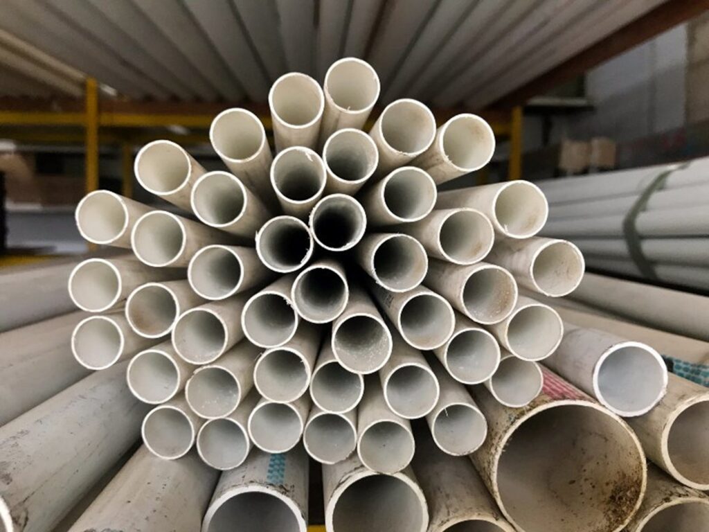 A pile of white poly-B piping by Hydro-Flo Plumbing & Heating